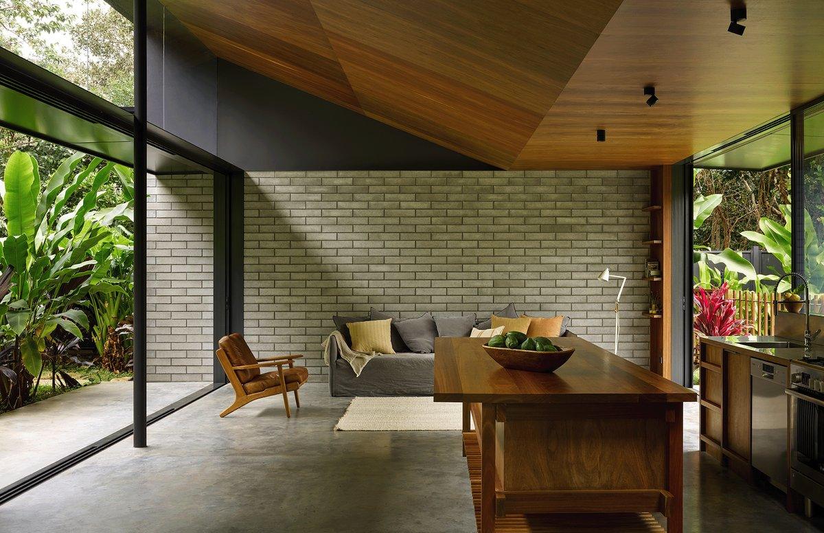 Open living space with brick feature wall and timber kitchen island