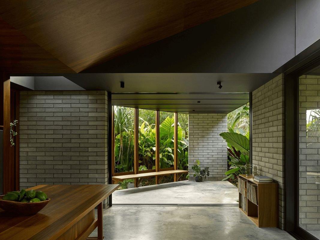 Living area framed by brick walls looking out to the garden