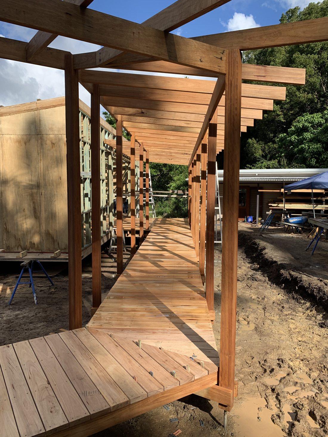 Poolside timber pergola with pitched roof and skylights